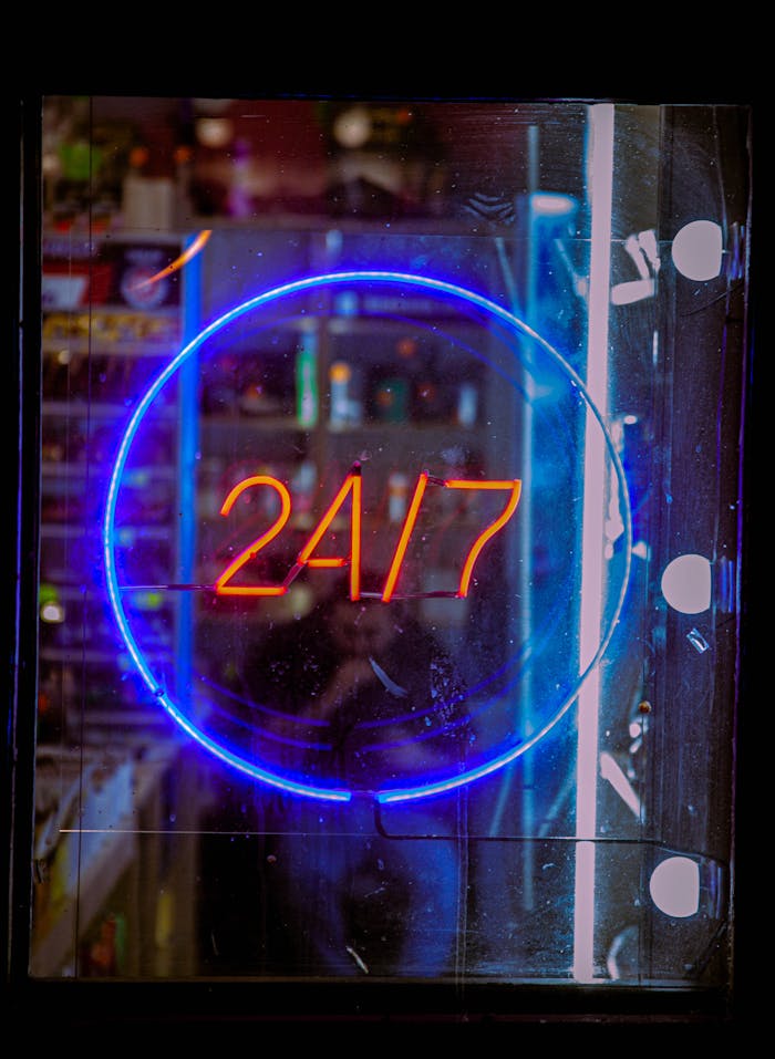 The Art of Drawing Readers In: Your attractive post title goes here Vibrant neon blue and red 24/7 sign glowing in a shop window at night, creating a bustling urban vibe.
